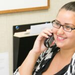 Smiling young woman in a professional setting, highlighting career opportunities and youth empowerment