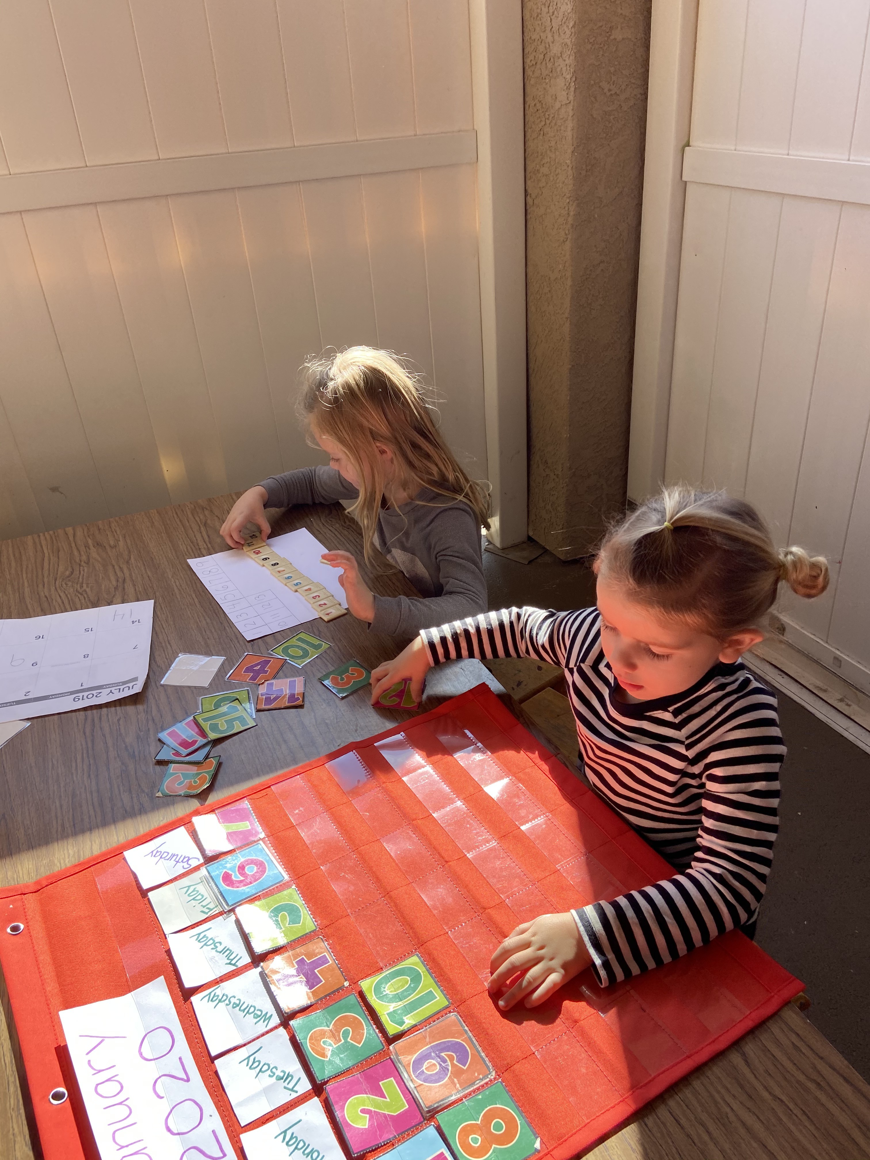 Two girls counting objects, learning early math skills at Ardenwald Preschool