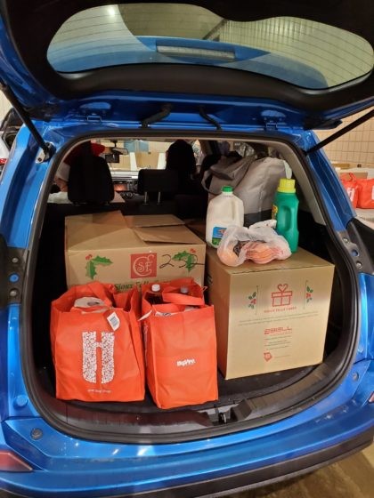 Volunteers deliver Sioux Falls Cares Christmas Program boxes, bringing holiday cheer to families in need.