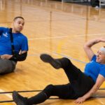 Soldiers engaging in a volleyball drill during adaptive sports training.