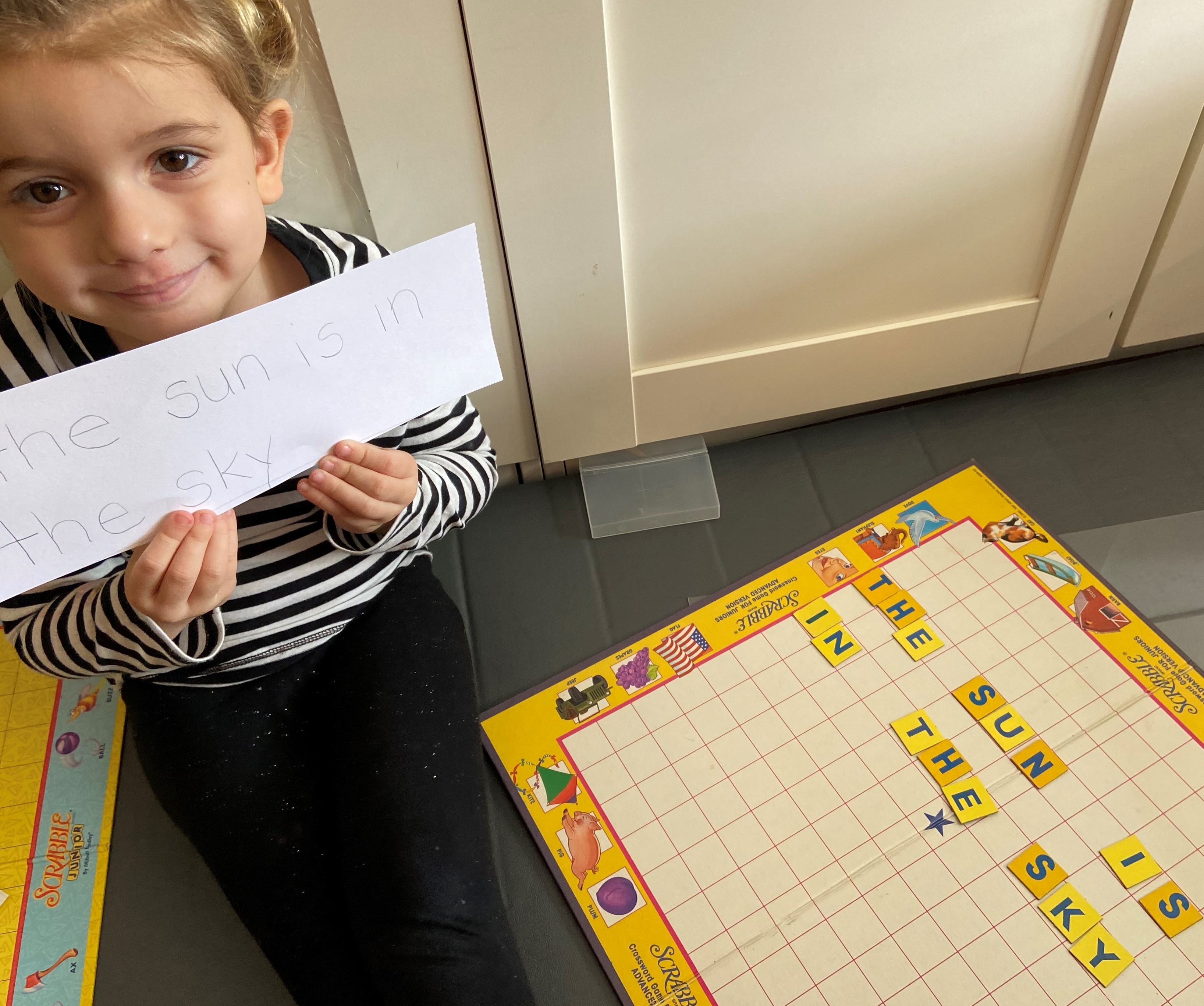 Girl reading a book, fostering literacy skills at Ardenwald Preschool