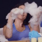 Person playfully enjoying a bubble bath, highlighting the cliché of traditional self-care