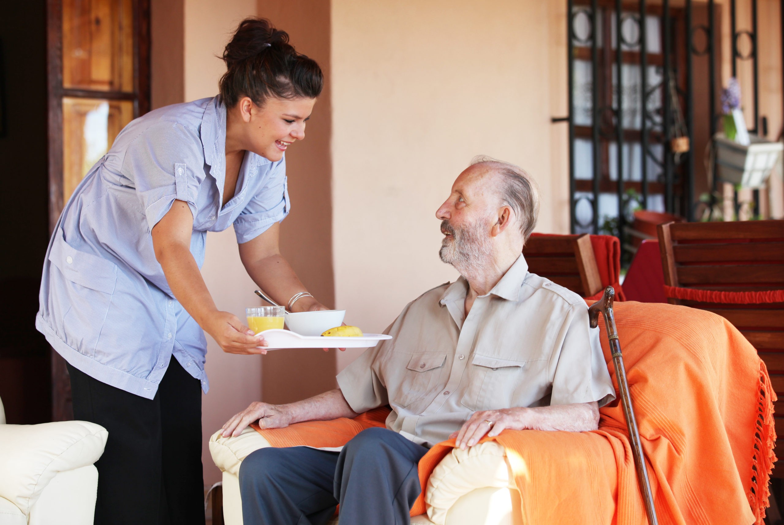 Aged care support program providing in-home meal assistance for a senior, highlighting home care services for the elderly.