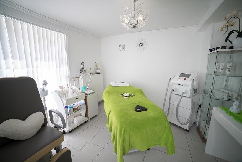 Inside of a health care facility office with patient examination table and medical equipment, highlighting a setting relevant to acute care psychiatric services.