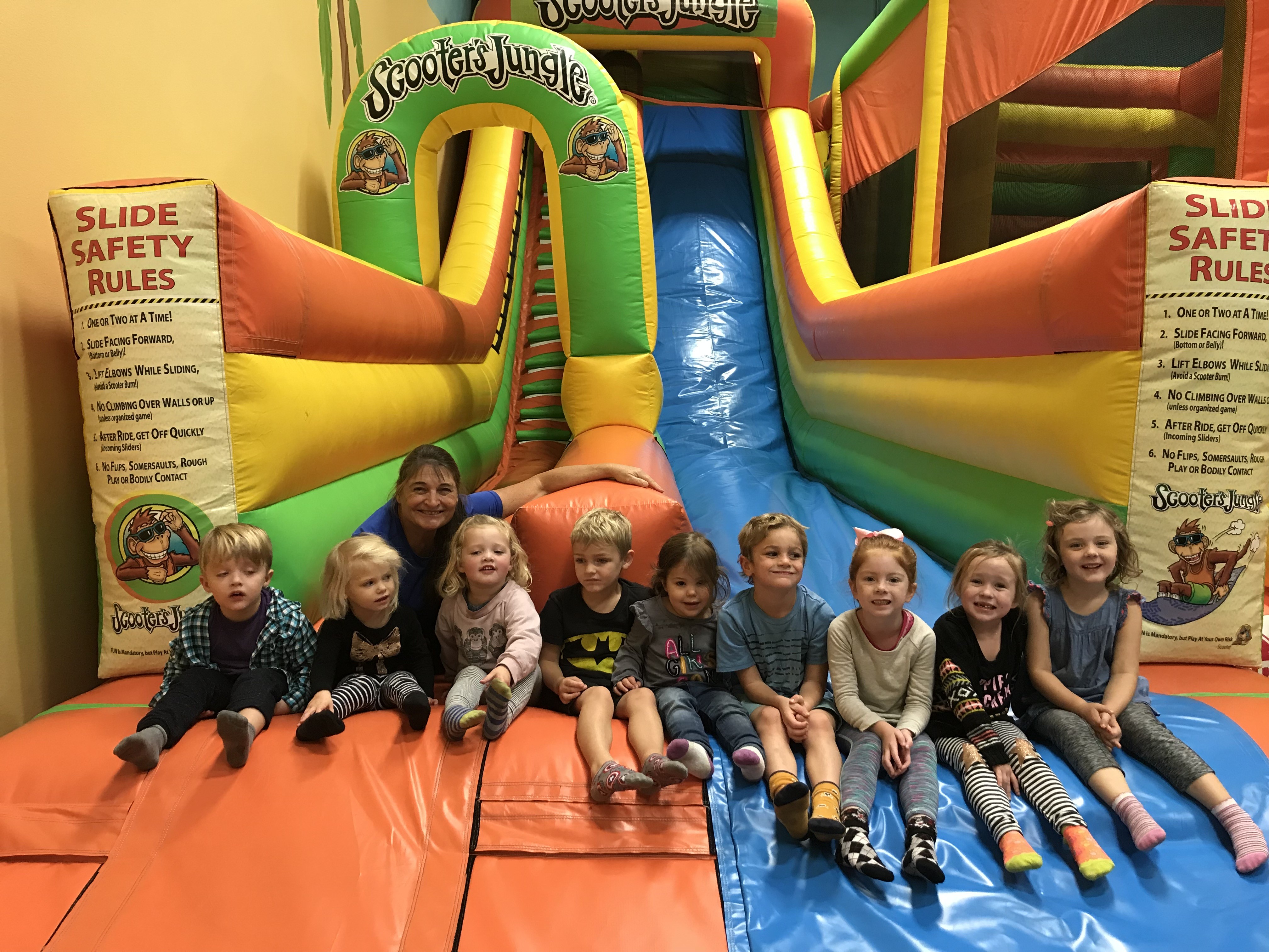 Child having fun on a rainbow slide, engaging in active play at Ardenwald Preschool