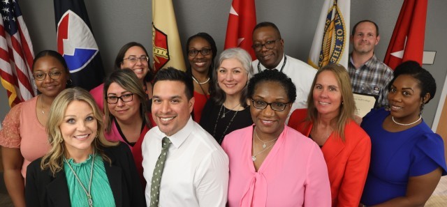 Group photo of twelve IMCOM professionals who graduated from the Civilian Education System Intermediate Course, showcasing the Army Career Skills Program IMCOM commitment to professional development. Graduates include Regina Martinez, Jaime Ruiz, Andrea Burton, Marilynn Rivera-Santiago, Darlene Pantoja, Brenda Bailey, Senitta Conyers, Brittany McClure-Crawford, Anitra Kinder, Dorothy Jefferson, Keith Richardson, and Ryan Guffey.