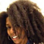 Smiling woman with healthy natural hair