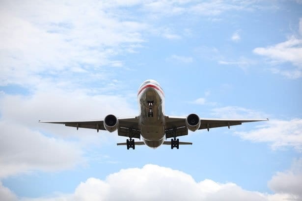 Airplane landing approach at airport, showcasing pilot career aspiration